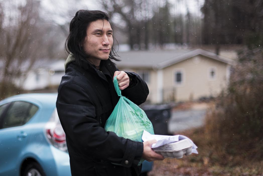 Man holding bag and egg carton
