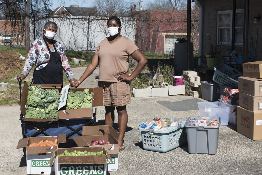 Marcella Thompson and daughter with vegetable boxes