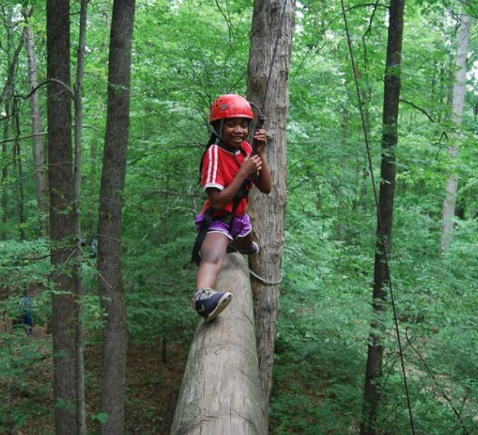 Child walking across log