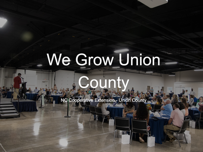 We Grow Union County in front of picture of people at a dinner