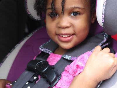 Young girl in a car seat installed correctly