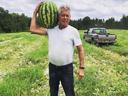 Outstanding in his field: Jim Lambeth shows off a giant watermelon he grew.
