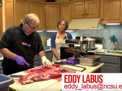 Man cutting meat on counter