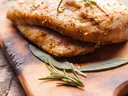 Baked Chicken Breasts with Herbs on a Cutting Board