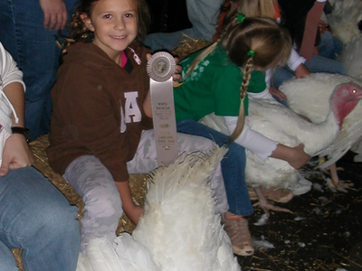 Girl with turkey and ribbon