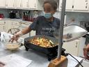 Zoey Woods prepares chicken stir fry at a Cooking 4-H Club event in July 2021.