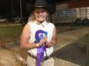 Alyssa Snyder beams after winning the champion dairy goat award at the 2021 fair. This was her first time participating.