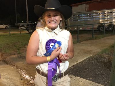 Alyssa Snyder beams after winning the champion dairy goat award at the 2021 fair. This was her first time participating.