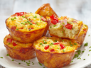 Egg Muffins on a plate sprinkled with fresh chives