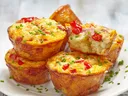 Egg Muffins on a plate sprinkled with fresh chives