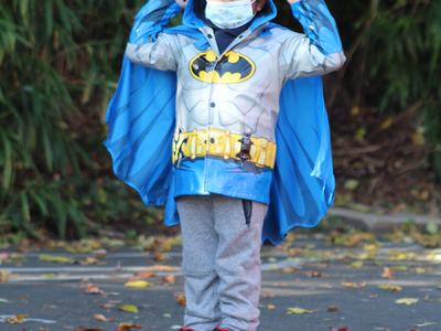 Young boy in a blue Batman raincoat