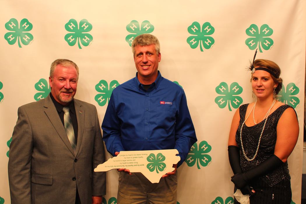 Three adults looking at camera