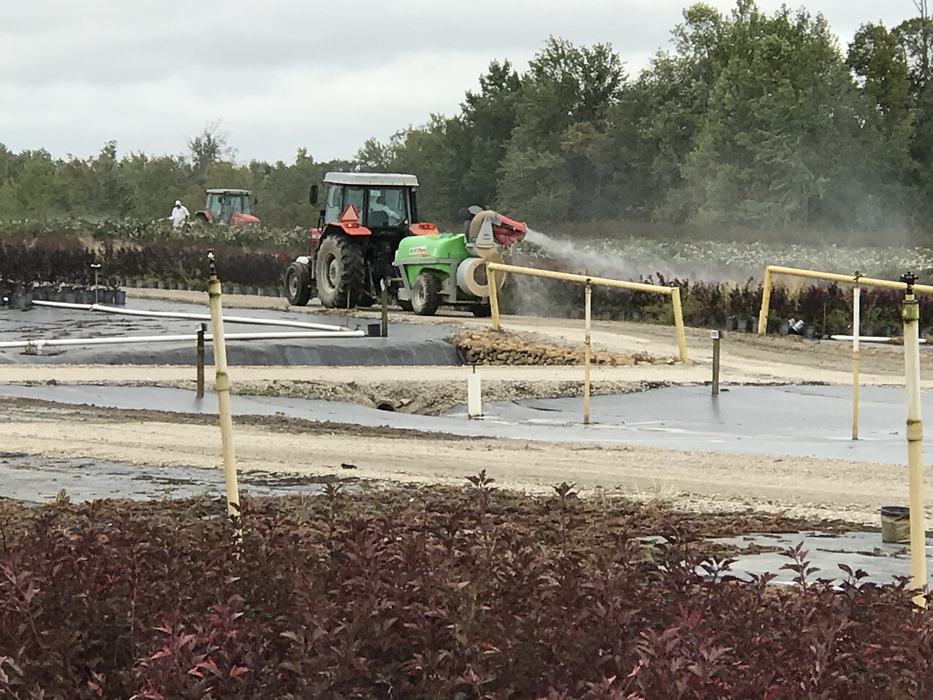 Tractor spraying insecticide