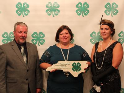 3 adults looking at camera