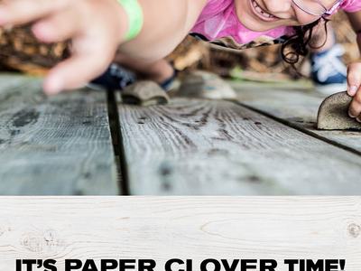 Girl climbing wooden wall reaching upward; text: "IT'S PAPER CLOVER TIME! OCTOBER 6-17TH 2021"