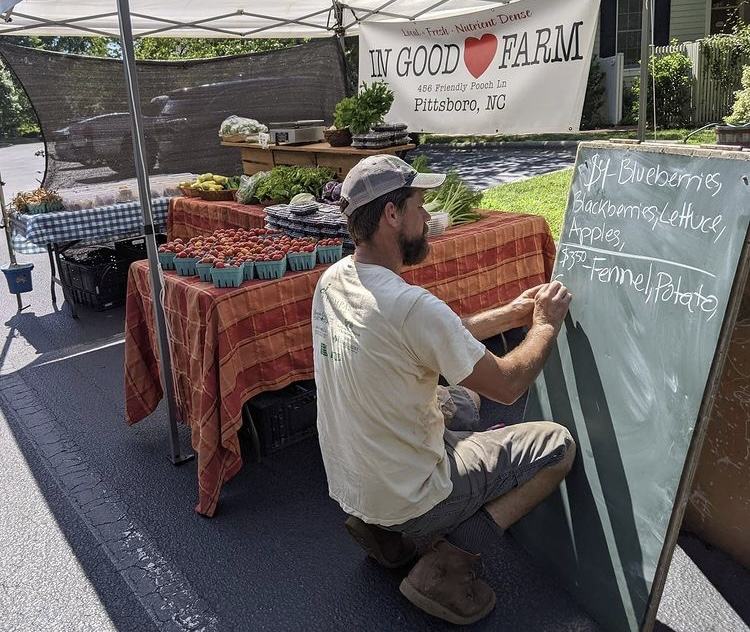 Benjamin Sheilds of In Good Heart Farm at the Fearrington Farmers Market. Photo Credit: Debbie Roos