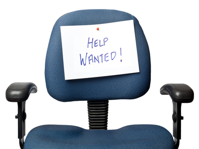 Office chair with a pinned paper sign reading "HELP WANTED!"