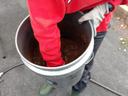 hand in a bucket of soil