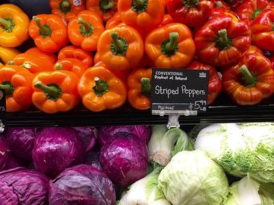 Orange, yellow, red striped bell peppers, purple and green cabbage