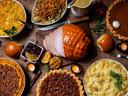 Display of traditional thanksgiving foods including pecan pie, ham, and stuffing