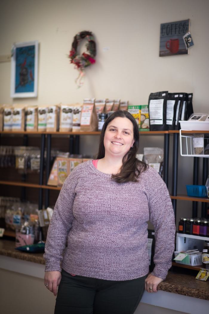 Woman in front of shelves