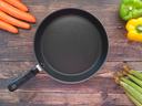 empty pan with vegetables surrounding it