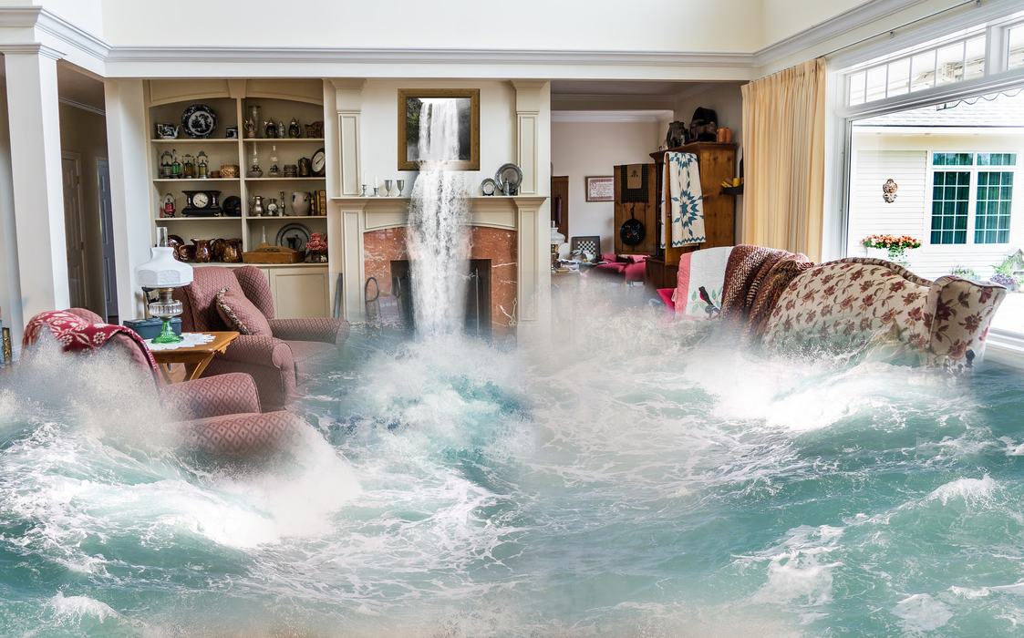 Living room flooded by ocean waves with a waterfall pouring from the fireplace