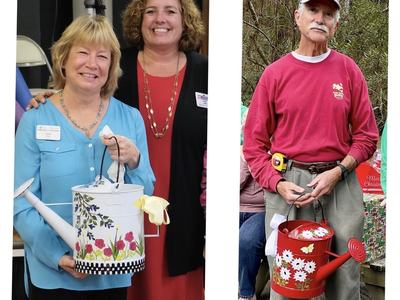 Two women indoors holding white floral watering can; man outdoors holding red floral watering can