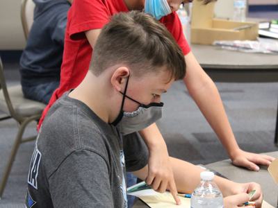 Wilson Deal and Drew Penny work together on a cipher activity during the 2021 4-H STEM Challenge: Galactic Quest event last fall.