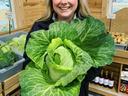 girl smiling and holding cabbage