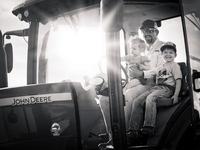 Jason Brown and 2 children on a tractor