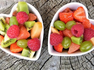 2 heart-shaped bowls of fresh fruit