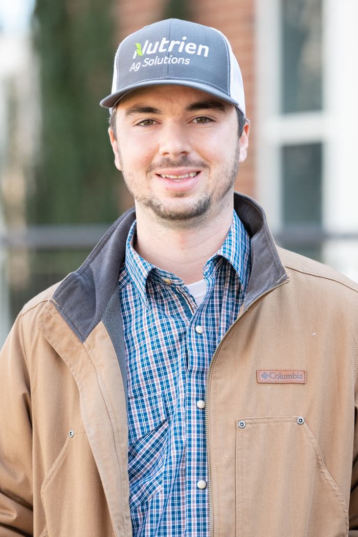 Young man wearing "Nutrien Ag Solutions" cap and a Columbia jacket