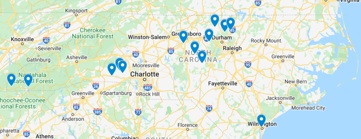 North Carolina map with blue markers near Asheville, Charlotte, Greensboro/Durham, and Wilmington.
