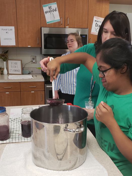 HHS student learning proper canning techniques