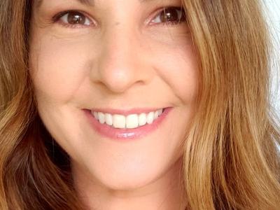 Smiling woman close-up with long light brown hair