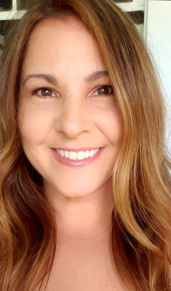 Smiling woman close-up with long light brown hair