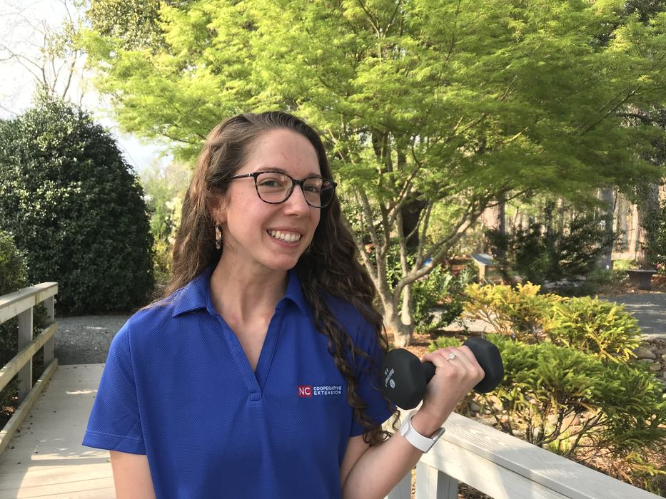 FCS Agent, Rachel Bland holding a dumbbell and smiling