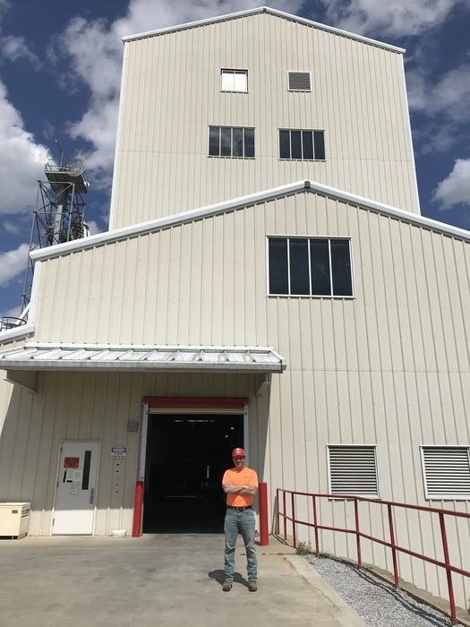 sam brown standing in front of feed mill education unit