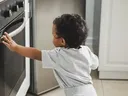 baby touching stove