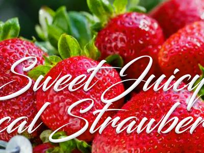Close-up of ripe strawberries with overlaid text "Sweet Juicy Local Strawberries"