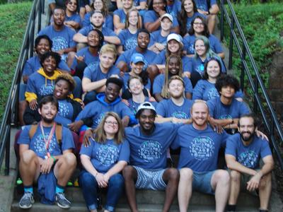 group of camp employees sitting on steps