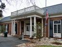 Charles R. Jonas Library brick building with columns and American flag