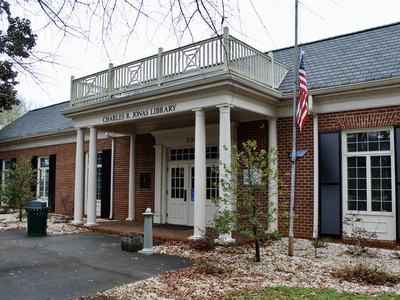 Charles R. Jonas Library brick building with columns and American flag