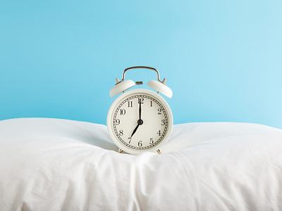alarm clock on pillow