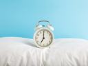 alarm clock on pillow