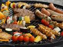 Grill with skewered chicken, sausages, steaks and assorted vegetable kebabs