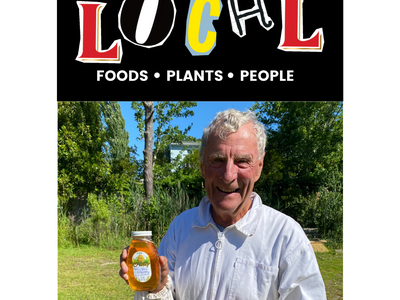 Older man in beekeeping suit holding jar of honey beneath "LOCAL" and "FOODS • PLANTS • PEOPLE"