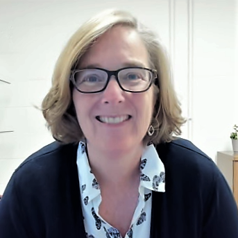 Esther Morris smiling at the camera while sitting at her desk at NC State University