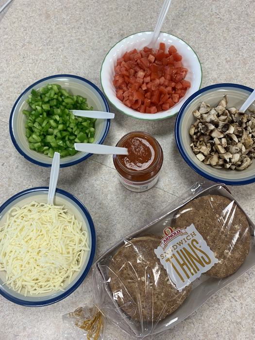 Ingredients for making pizza in bowls.